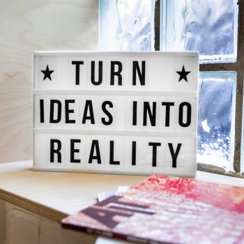 a lightbox says turn ideas into reality. It sits on a sideboard. A foundation marketing plan is all about turning your ideas into reality.