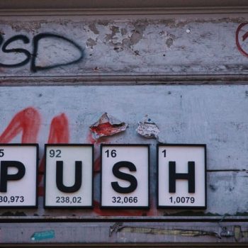 On a grafitti covered wall, the word push is spelt out in tiles. You have to push the limits when you have a new business