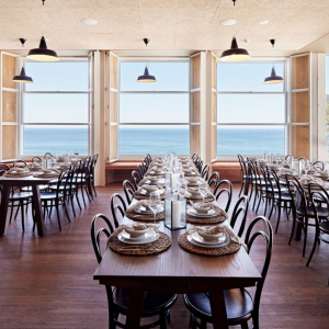 a dining room overlooks the ocean and sky 