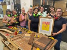 a smiling group of women in a workshop make up Parramatta Women's Shed